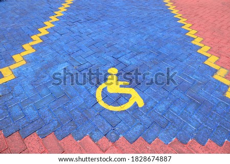image of handicapped symbol shows sign reserved for disability person on car parking space