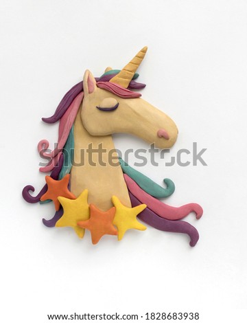 Portrait of a cute unicorn with stars on his neck. Plasticine illustration on white background Royalty-Free Stock Photo #1828683938