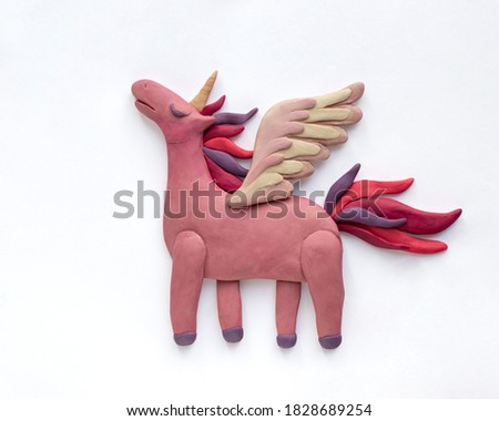Pink plasticine unicorn with wings. Cute plasticine illustration on white background