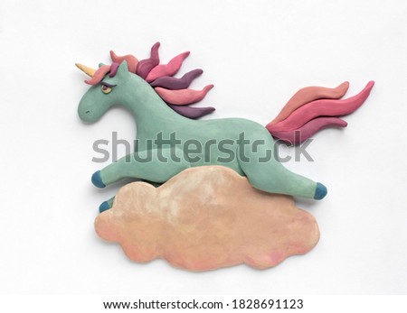 A blue plasticine unicorn with a pink-purple mane flies on a cloud. Cute illustration on white background