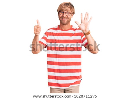 Handsome caucasian man with beard wearing casual clothes and glasses showing and pointing up with fingers number six while smiling confident and happy. 