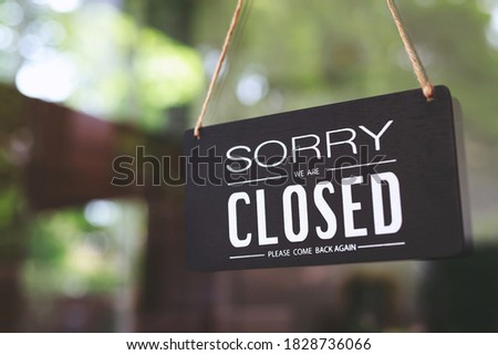 sorry closed sign on shop door. Text on cafe front or restaurant hang on door at entrance. vintage tone style. Royalty-Free Stock Photo #1828736066