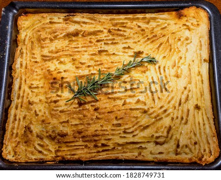 Shepherd's Pie Casserole. Isolated. Copy Space. Baked  pie casserole with a branch of rosemary on the top. Top view. Stock Image.
