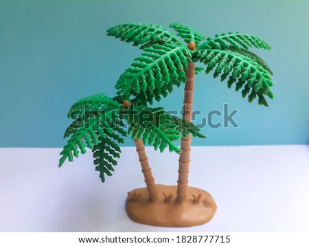 Toy Palm Tree On Blue And White Background Stock Photo