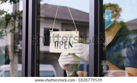 Welcome open sign board hanging on glass door at the coffee shop.