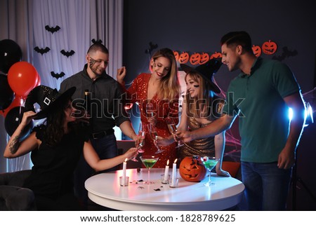 Group of friends having Halloween party at home