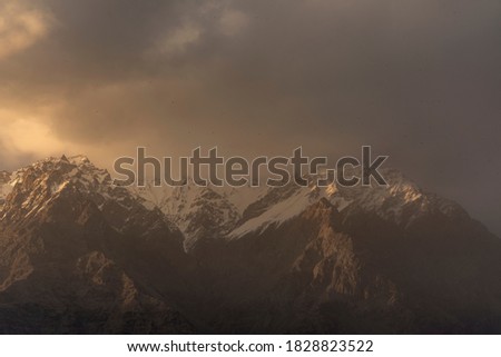 snow mountains in golden light of sunset , in Karakorum range , skardu , gilgit baltistan
 