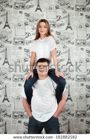 Happy young couple in love posing at studio