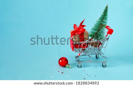 christmas online shopping concept. Shopping cart with gifts, Christmas decor, Christmas tree on a blue background. background. 3d illustration. Copy space, banner