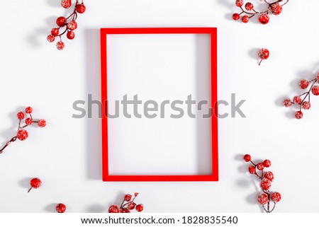 Christmas holiday composition. Red photo frame and red berry on white background. Christmas, New Year, winter concept. Flat lay, top view, copy space