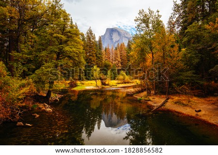 The view from within Yosemite Valley of surrounding rock faces and Merced River on a stormy day in California, USA Royalty-Free Stock Photo #1828856582