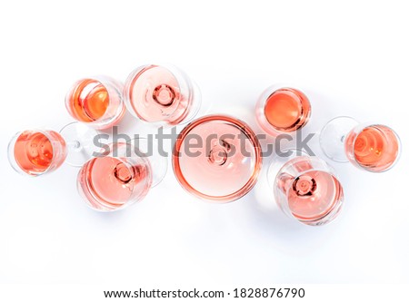Rose wine glasses on wine tasting. Degustation different varieties of pink wine concept. White background, top view, hard light  Royalty-Free Stock Photo #1828876790