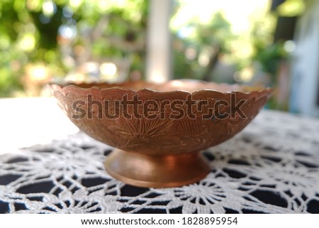 Engraved brass bowl on the table stock photo