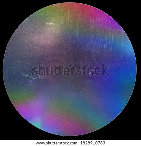 holographic neon sticker on real paper sheet isolated on black background with scratches and dust marks.