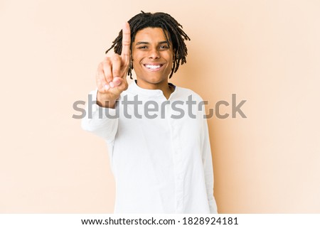 Young african american rasta man showing number one with finger.