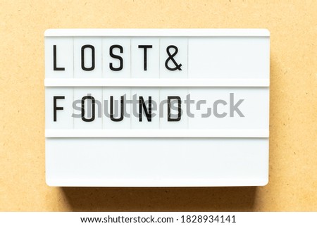 Lightbox with word lost & found on wood background