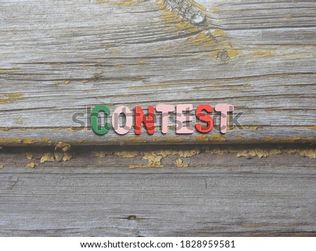 Word Contest on wood background