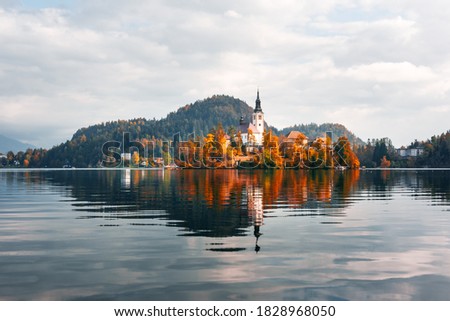 Colorful autumn view of Bled lake in Julian Alps, Slovenia. Pilgrimage church of the Assumption of Maria on a foreground. Landscape photography