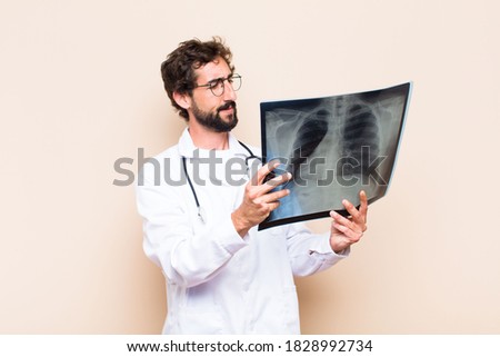 young physician man holding a bone scan.