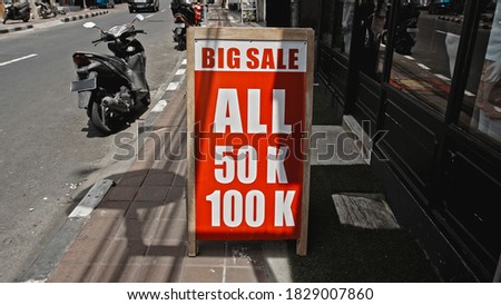 White text on a red sign with the inscription big sale