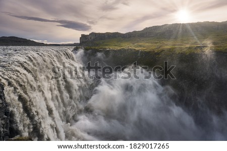 Beautiful sunset at the Dettifoss waterfall. Imposing bed of the Dettifoss waterfall                