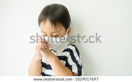 Little toddler boy keep praying for world pandemic coronavirus Covid-19 banner white background.Stay at home praying to GOD.Online church worship in sunday.Hands praying at home.Religion, Christian.
