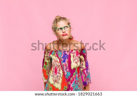 middle age woman looking puzzled and confused, wondering or trying to solve a problem or thinking