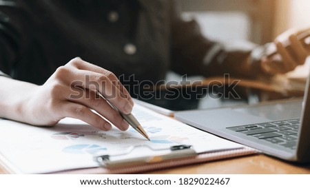 Business man investment consultant analyzing company annual financial report balance sheet statement working with documents graphs. Concept picture of business, market, office, tax.
