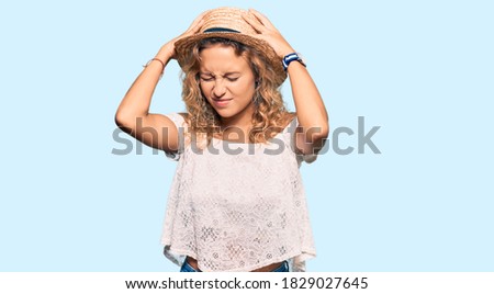 Beautiful caucasian woman wearing summer hat suffering from headache desperate and stressed because pain and migraine. hands on head. 