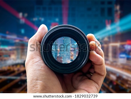 Camera lens on capital background