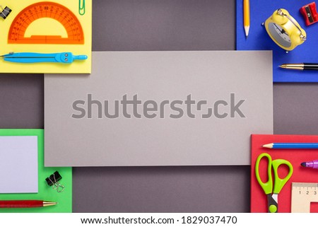 school accessories and office supplies at abstract colorful paper background