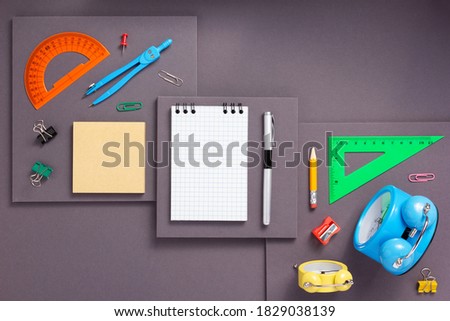 school accessories and office supplies at abstract gray paper background