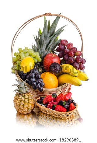 still life of  multi-coloured fruits in big  basket, on white background, isolated