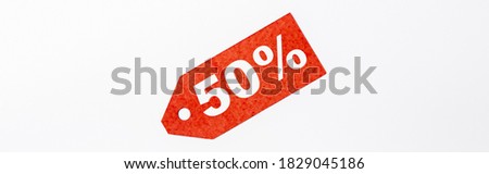 Panoramic crop of red price tag with 50 percent signs on white background