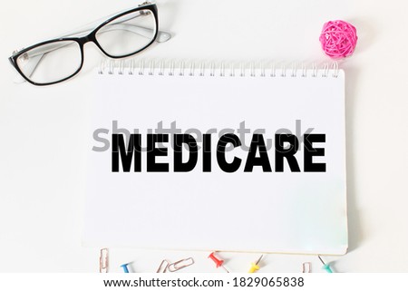 Notepad with inscriptions MEDICARE on a white background. business concept.