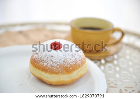 Hanukkah symbol jewish food holiday image of donut with jelly and sugar powder.