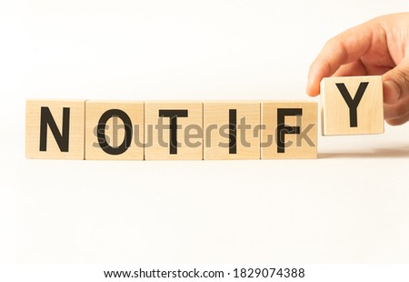 Word notify. Wooden small cubes with letters isolated on white background with copy space available.Business Concept image.