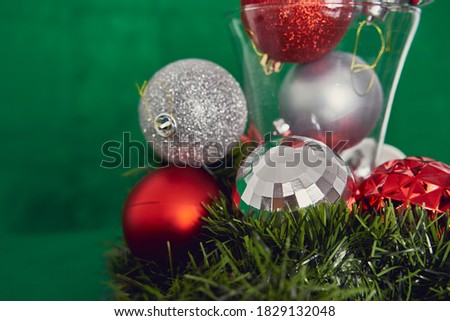 Christmas decoration with balls, the green background. Christmas seasonal decoration.                               