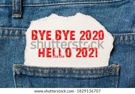 bye bye 2020 hello 2021 on white paper in the pocket of blue denim jeans
