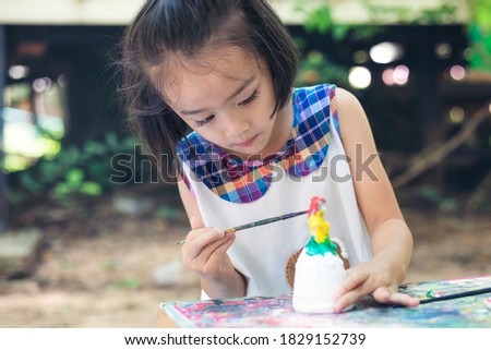 Cute little girl is learning outside the classroom happily with beautiful nature And a bright smile