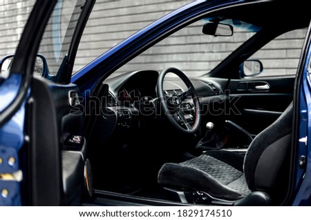 Steering wheel on the car dashboard and the driver's seat
