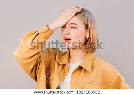 Gosh why me. Portrait of unhappy displeased and annoyed young arrogant woman facepalming with irritation breathing out with opened mouth and rolling eyes from annoyance and exhaust