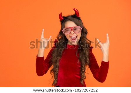 happy kid wear devil horns and glamour party glasses on halloween, happy halloween party fun.