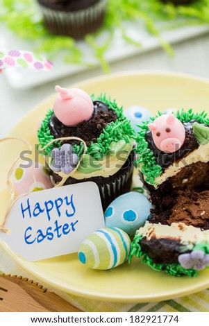 Easter chocolate cupcakes decorated with piggy and bunny ears.
