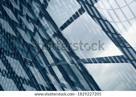 Double exposure photo of structural glazing. Windows of hi-tech building. Abstract modern architecture. Geometric background of frames. Polygonal pattern of transparent panels in diagonal perspective.