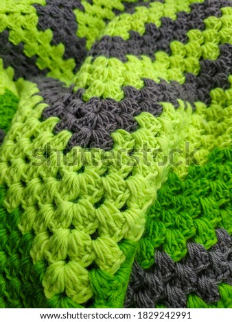 Close-up. Crocheted light green plaid. High quality photo