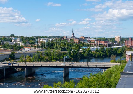 Manchester historic city skyline including Merrimack River, Granite Street Bridge and West Side Sainte Marie Parish church in Manchester, New Hampshire NH, USA.  Royalty-Free Stock Photo #1829270312