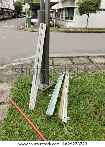 Outdoor scenery in the morning with broken fluorescent lamp set near street lamp pole.Image may contain noise or grain due to low light.Selective focus.