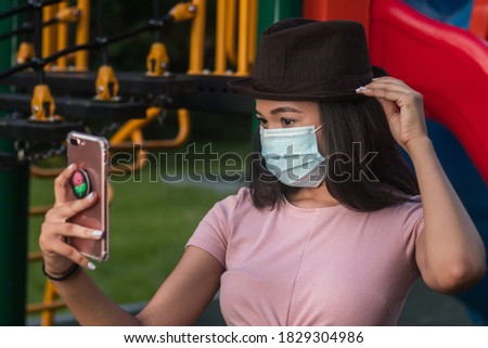 
Young beautiful girl, taking a selfie wearing the mask, respecting the new normal.