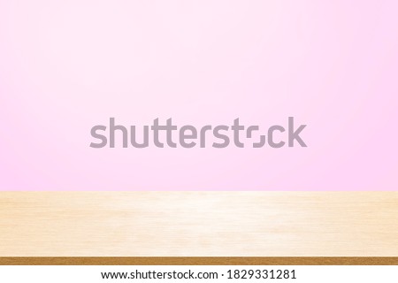 Empty wooden deck table over mint wallpaper background for present product.